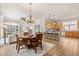 Open-concept living area with dining space and kitchen featuring tile floors and modern decor at 3603 Westover Cir, Leesburg, FL 34748