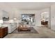 Cozy living room showcasing a sliding glass door to the patio and open access to the chandelier lit dining area at 3603 Westover Cir, Leesburg, FL 34748