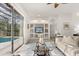 Stylish living room with a sliding glass door to the pool and built-in shelving for displaying decor and entertainment at 3603 Westover Cir, Leesburg, FL 34748