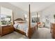 Main bedroom featuring a four-poster bed, large windows, and a door to the pool area at 3603 Westover Cir, Leesburg, FL 34748