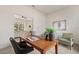 Office space with desk, chairs, and view into the living room at 3603 Westover Cir, Leesburg, FL 34748
