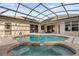 Enclosed pool with hot tub and large patio area at 3603 Westover Cir, Leesburg, FL 34748