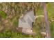 Overhead shot of a home showing the roof, driveway, landscaping, and surrounding greenery at 37 Spring Ln, Haines City, FL 33844