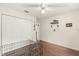Bedroom with wood floors, closet, ceiling fan, and bright walls at 37 Spring Ln, Haines City, FL 33844