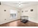 Bedroom with wood floors, window, ceiling fan, and pet crate at 37 Spring Ln, Haines City, FL 33844