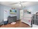 Baseball-themed Bedroom with crib, dresser, TV, and wood floors at 37 Spring Ln, Haines City, FL 33844