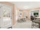 Bright breakfast nook with a table setting, windows, and a view into the living room at 37 Spring Ln, Haines City, FL 33844