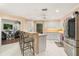 Bright eat-in kitchen featuring white cabinetry, stainless steel appliances, and tiled floors at 37 Spring Ln, Haines City, FL 33844
