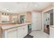 Bright kitchen with white cabinets, white appliances, and tiled flooring at 37 Spring Ln, Haines City, FL 33844