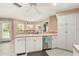 Bright eat-in kitchen featuring white cabinetry, white appliances, and tiled floors at 37 Spring Ln, Haines City, FL 33844