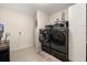 Spacious laundry room with black washer and dryer and ample storage space at 37 Spring Ln, Haines City, FL 33844