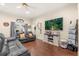 Cozy living room with hardwood floors, a large TV, and comfortable seating, perfect for Gathering gatherings at 37 Spring Ln, Haines City, FL 33844