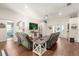 Open-concept living room with hardwood floors, comfortable seating, and plenty of natural light at 37 Spring Ln, Haines City, FL 33844