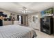 Main bedroom with a white dresser, safe, tv, and wood floors at 37 Spring Ln, Haines City, FL 33844