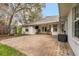 Rear patio area for entertaining, with paved bricks, partial roof, and outdoor cooking space at 37 Spring Ln, Haines City, FL 33844