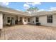 A brick-paved patio is perfect for outdoor entertainment, with a built-in grill and ample seating space at 37 Spring Ln, Haines City, FL 33844