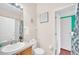 Bright bathroom with single vanity, toilet, tub/shower combo, and neutral decor at 438 Miramar Ave, Davenport, FL 33897
