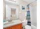 Bathroom features a single sink vanity, shower-tub, and decorative shower curtain at 438 Miramar Ave, Davenport, FL 33897