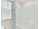 Bathroom boasts a white tub and a shower with a decorative shower curtain at 438 Miramar Ave, Davenport, FL 33897