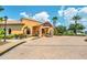 Community clubhouse featuring golf carts, detailed architecture, and brick entrance at 438 Miramar Ave, Davenport, FL 33897