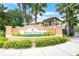Welcoming Regal Palms sign surrounded by lush tropical landscaping and mature palm trees at 438 Miramar Ave, Davenport, FL 33897