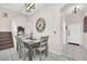 Dining area featuring a wooden table, seating for six, and a decorative wall clock at 438 Miramar Ave, Davenport, FL 33897