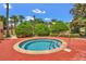 Relaxing hot tub, perfect for unwinding, surrounded by tropical greenery and mature trees at 438 Miramar Ave, Davenport, FL 33897