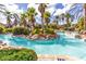 Inviting lazy river with lush landscaping and waterslide for endless summer fun at 438 Miramar Ave, Davenport, FL 33897