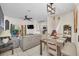 Bright living and dining area with modern light fixtures and comfortable gray sofas at 438 Miramar Ave, Davenport, FL 33897