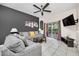 Comfortable living room with a gray sofa, ceiling fan, and sliding doors to the outdoor area at 438 Miramar Ave, Davenport, FL 33897