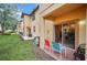 Outdoor patio with seating overlooking green space and neighboring buildings at 438 Miramar Ave, Davenport, FL 33897