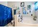 Charming primary bathroom features a mermaid theme with custom wall art at 442 Jessamine Dr, Davenport, FL 33837