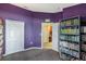 Unique purple bedroom has a large closet and additional shelving at 442 Jessamine Dr, Davenport, FL 33837