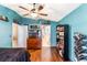 Bright bedroom features wood floors, updated fixtures, ceiling fan, and stylish decor at 442 Jessamine Dr, Davenport, FL 33837