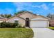 Charming single-story home with a well-maintained lawn and attached two car garage at 442 Jessamine Dr, Davenport, FL 33837