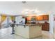 Modern kitchen with an island, granite countertops, stainless steel appliances, and breakfast bar at 442 Jessamine Dr, Davenport, FL 33837