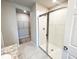 Bright bathroom featuring a glass-enclosed shower and a view into the walk-in closet at 464 Patricia Alford Dr, Haines City, FL 33844