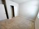 View of the bedroom with carpet, closet, base trim and neutral colored walls at 464 Patricia Alford Dr, Haines City, FL 33844