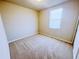 Cozy bedroom with carpet, base trim and neutral walls with a bright window at 464 Patricia Alford Dr, Haines City, FL 33844