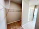 View into the walk-in closet, connected to the bathroom, with carpeted floor and shelving at 464 Patricia Alford Dr, Haines City, FL 33844