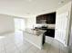 Bright kitchen with granite island, dark cabinets and nearby dining area at 464 Patricia Alford Dr, Haines City, FL 33844