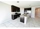 Kitchen with a large island, dark wood cabinets, and granite countertops at 464 Patricia Alford Dr, Haines City, FL 33844