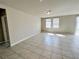 Bright living room with neutral walls, tile flooring, and natural lighting at 464 Patricia Alford Dr, Haines City, FL 33844