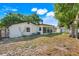 Expansive backyard with mature trees and an outbuilding, perfect for storage or hobbies at 5202 Greenway Drive, Orlando, FL 32819