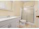 Bright bathroom with a walk-in shower and a neutral-toned vanity and sink at 5202 Greenway Drive, Orlando, FL 32819
