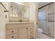 This bathroom features a vanity with stone countertop and a glass shower at 5202 Greenway Drive, Orlando, FL 32819