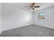 Well-lit bedroom with neutral carpet and one window providing natural light at 5202 Greenway Drive, Orlando, FL 32819