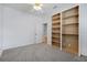 Bright bedroom featuring built-in shelving, plush carpeting, and a ceiling fan for added comfort at 5202 Greenway Drive, Orlando, FL 32819