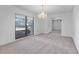 Light-filled dining room boasts a modern chandelier, neutral walls, carpet, and an open layout at 5202 Greenway Drive, Orlando, FL 32819