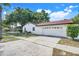 Charming single-story home showcasing a well-maintained exterior, a two car garage, and a spacious driveway at 5202 Greenway Drive, Orlando, FL 32819